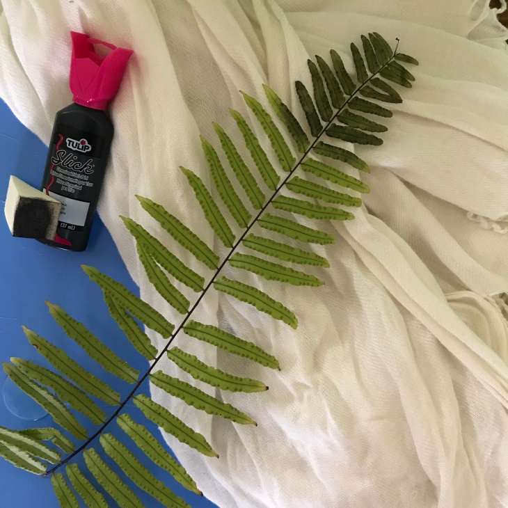 Materials used to turn a bandage-looking scarf into a beautiful leaf-printed piece of cloth